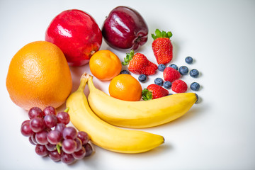 Fresh Organic Fruits on top of white table.