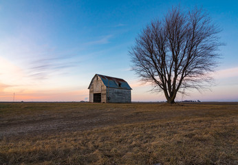 Fototapeta premium Old rustic barn as the sun sets. Ogle County, Illinois, USA