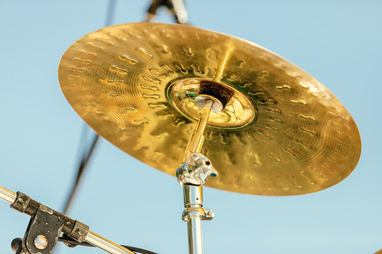 Close-up of a cymbal of a drums against blue sky