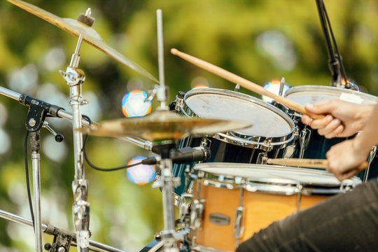 Close-up of drums and drummer's hands at an outdoor recital