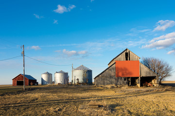 Fototapeta na wymiar Rural farm with brilliant blue skies and clouds in background. Putnam County, Illinois, USA