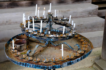 Circle old menorah Buddhist people lighting the candle pray to the buddha once they go to temple. White candles put surrounding in circle in menorah at a Buddhist shrine.