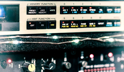 A close view of audio equipment effects rack, showing buttons and L.E.D lights.