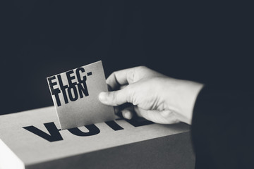 election card insert in vote box, democracy concept, black and white tone