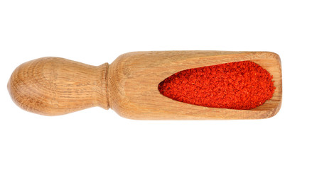 sweet paprika spice in a wooden spoon isolated on white background. Top view. Flat lay