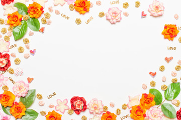 Frame made of rose flowers on white background. Top view with copy space.