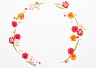 Frame made of rose flowers on white background. Top view with copy space.