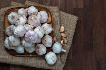 Garlic bulb and cloves in bamboo tray weave