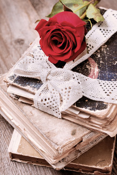 red rose and old books