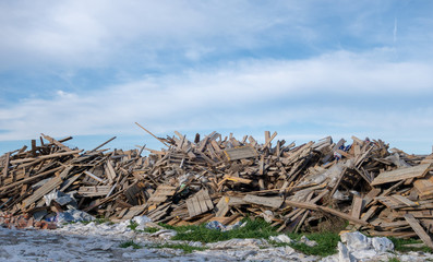 Pieces of wood destroyed after being used during the construction of the building. Big pile of garbage