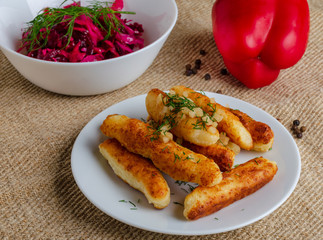 Breaded cheese and kefir sticks. Made from cheese, flour and kefir. Served with red salad.