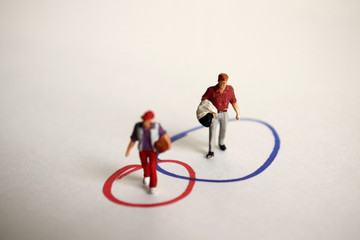 A miniature woman and a miniature man on the two overlapping circles in the other. The concept of...