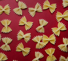arrangement of pasta in the form of a bow on a red background