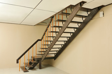 Home traditional style brown wooden stairs to the upper level.