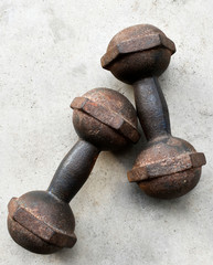 Fototapeta na wymiar Two dark brown lifting weights on the cement floor