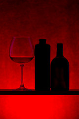 Still life with silhouettes of bottles and wine glass