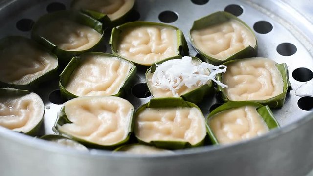 Woman making grate coconut and put it into bowl prepare for making Thai dessert 