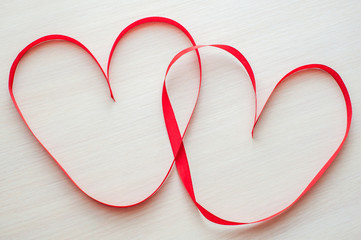 Two red ribbons shaped as heart