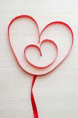 Two red ribbons shaped as heart. Heart in heart