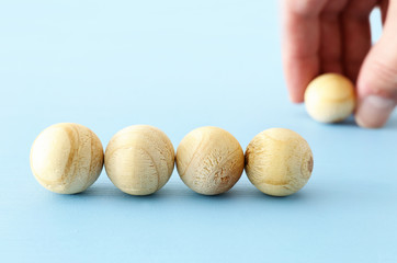 man hand arranging wooden beads. mock up or template.