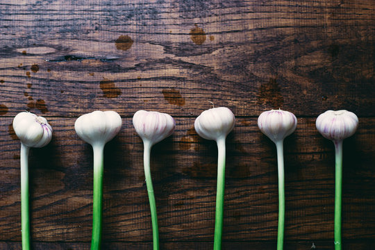 Healthy fresh organic garlic on a wooden table top view 