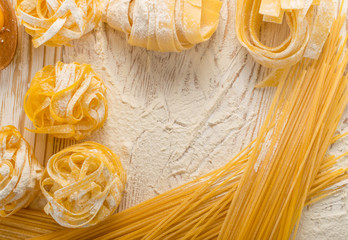 Raw yellow italian pasta pappardelle, fettuccine or tagliatelle