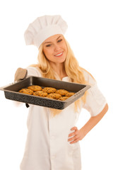 beautiful blond woman in chef dress bakes cookies isolated over white background