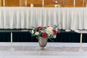 bouquet of wedding flowers in vase sitting on table