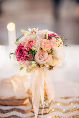 bouquet of wedding flowers in vase sitting on table