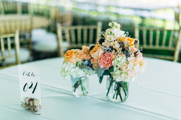 bouquet of wedding flowers in vase sitting on table