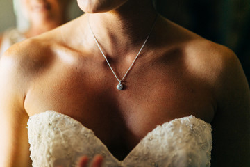 bride in wedding dress wearing a beautiful necklace
