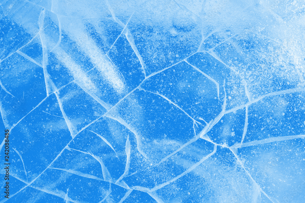 Wall mural abstract ice background. blue background with cracks on the ice surface