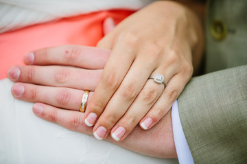 married couple holding hands over womans stomach