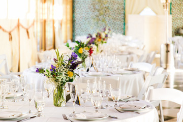 empty plated tables set for a wedding celebration dinner