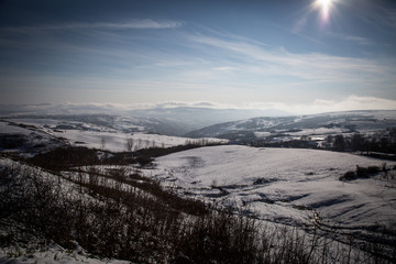 Snowy and sunny hills, aerial view 