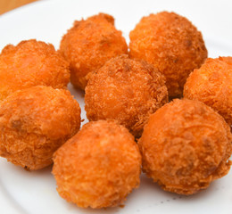 Cheese balls, Breaded mozzarella cheese balls with tomato in white dish on wood blackground