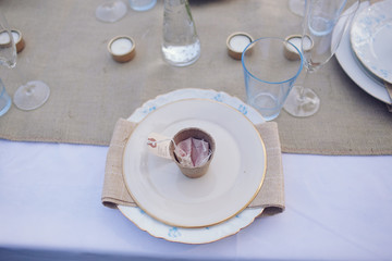 empty plated tables set for a wedding celebration dinner