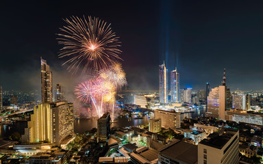 Celebration of New year with colorful fireworks on Chao Phraya riverside with Iconsiam building landmark of Bangkok