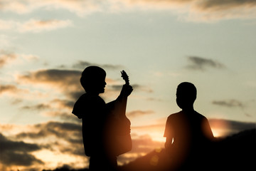 Two christian worship God and playing guitars with light sunset background,christian concept.