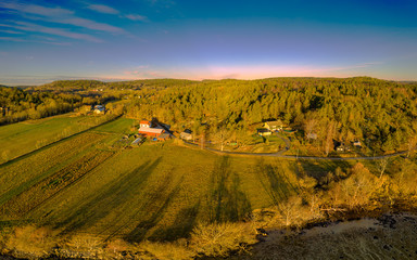 Fototapeta premium Aerial view with low evening sun of a rural idyll on Orust on the Swedish west coast