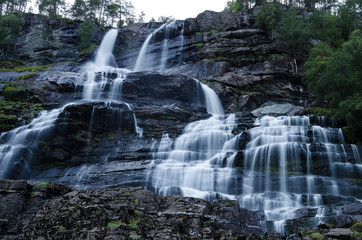 Fototapeta na wymiar Tvindefossen waterfall in Norway photographed on long exposure during dusk