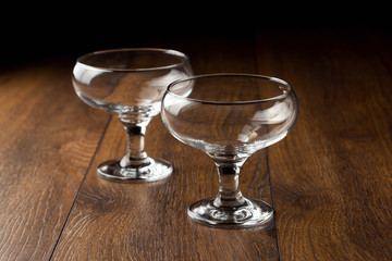 empty glass cups on a brown wooden background, tableware.