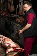 The chopping the meat, professional work of the butcher