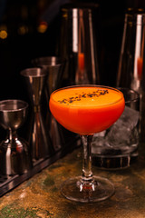 Alcoholic orange cocktail at the bar. Carrot Cocktail.