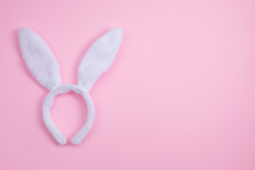 Easter bunny ears isolated on pink background. Happy Easter holiday background concept. Flat lay.
