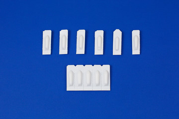 Medical Suppository, Rectal or Vaginal. Isolated on blue Background.