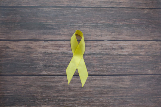 Yellow ribbon symbolic color for Sarcoma Bone cancer, Bladder cancer, Liver disease, Spina Bifida Awareness