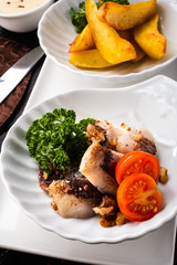 Herring snack with walnuts and cinnamon, garnished with baked potatoes.