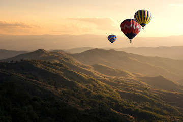 Hot air balloon flying over doi Chang at sunset ,Chiang Rai, Thailand © structuresxx