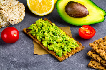 Avocado sandwich with avocado cream and rye crisp bread for snack. Fiber, fitness and diet food.